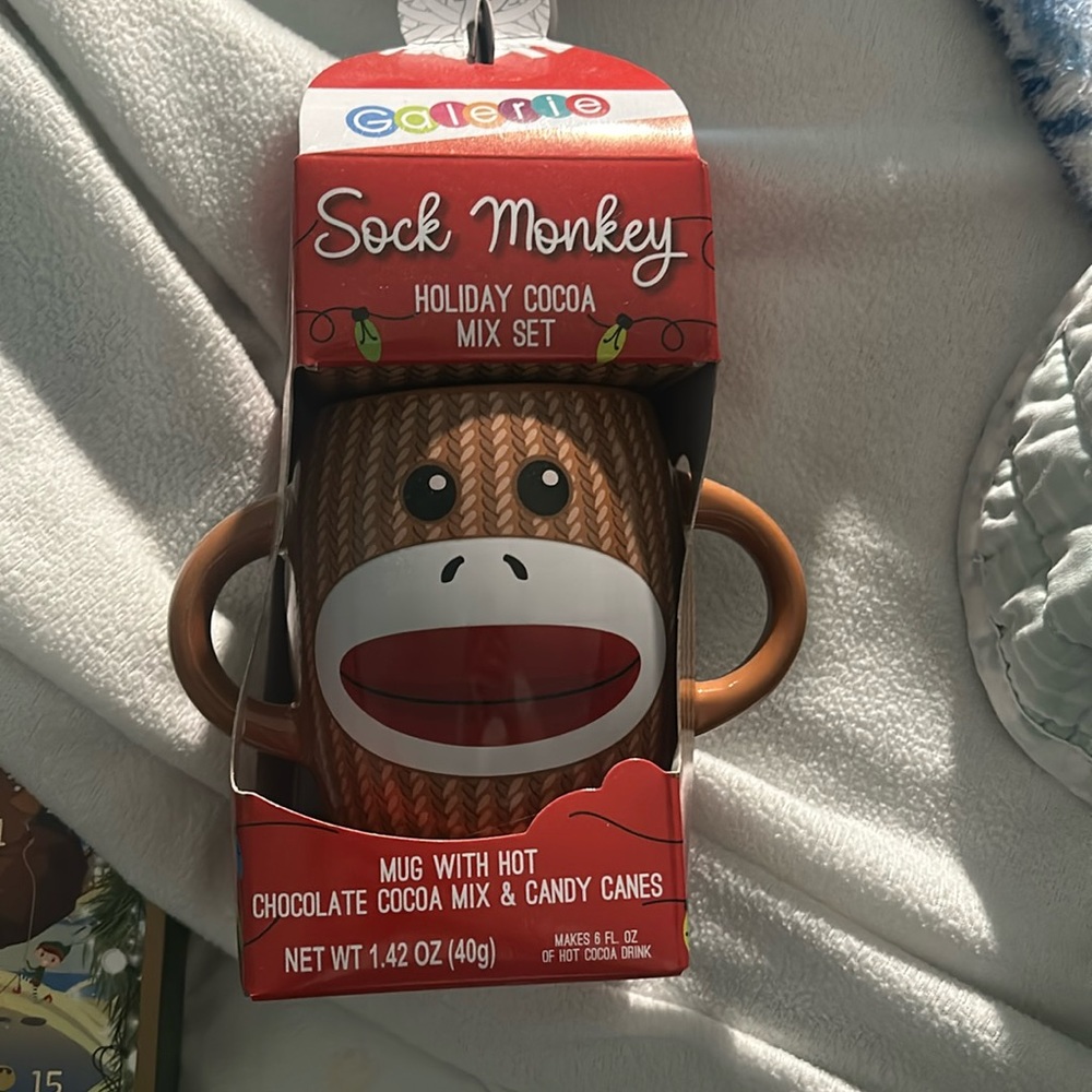 Sock monkey mug with chocolate cocoa mix and candy canes